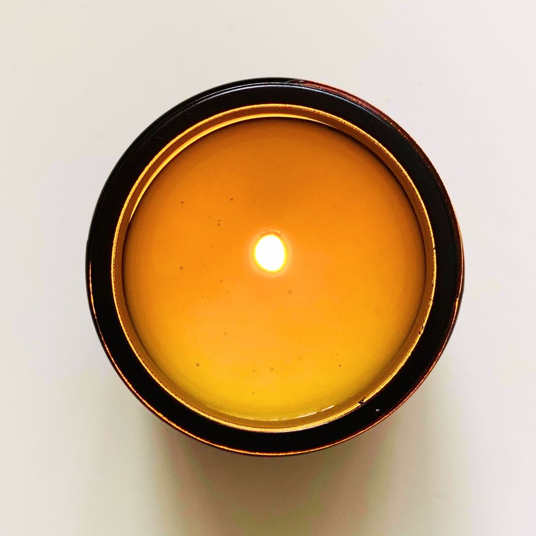 Ariel view of a lit candle in a black vessel